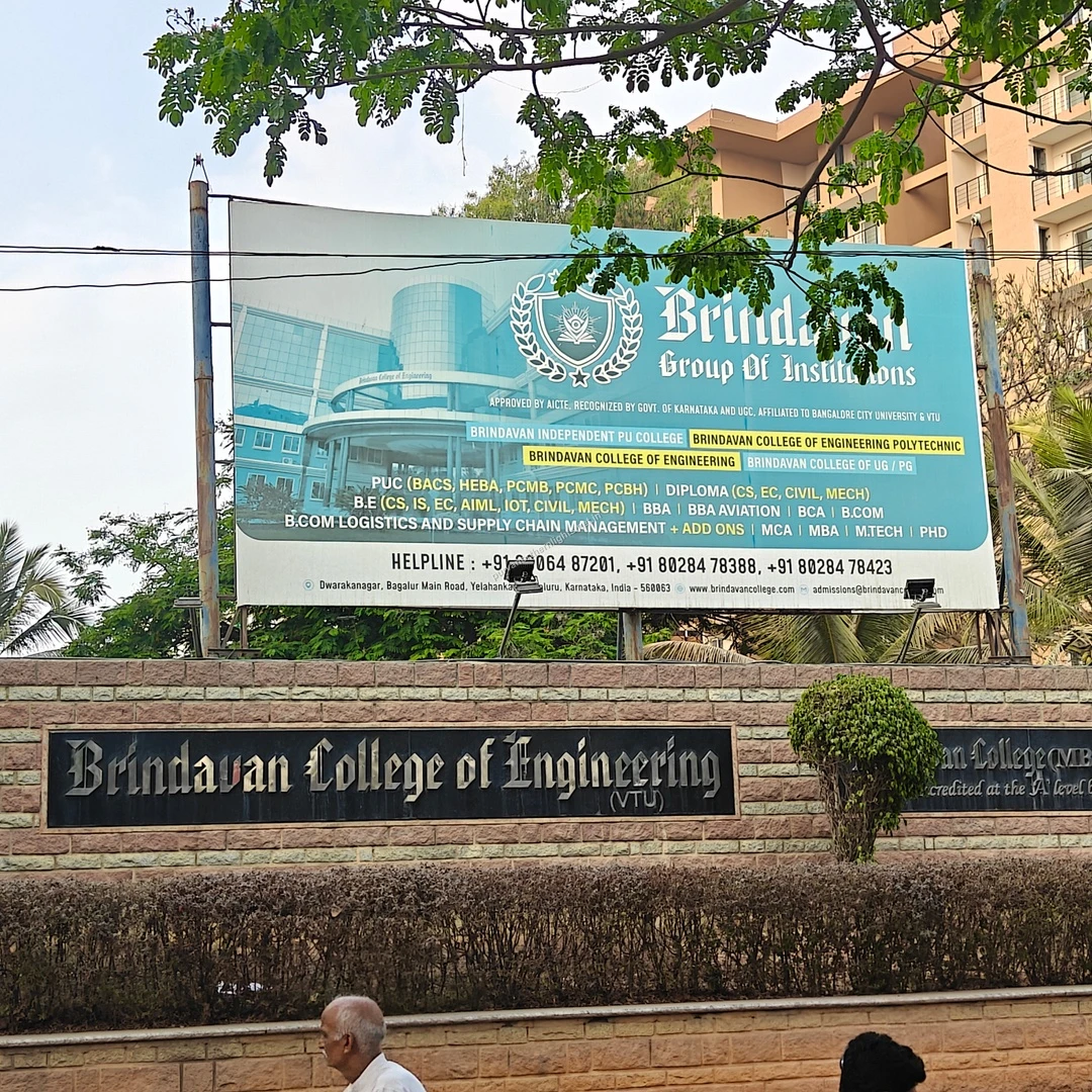 Brindavan College Wall The sturdy stone boundary wall and large informational billboard for Brindavan College of Engineering, an esteemed institution nearby.