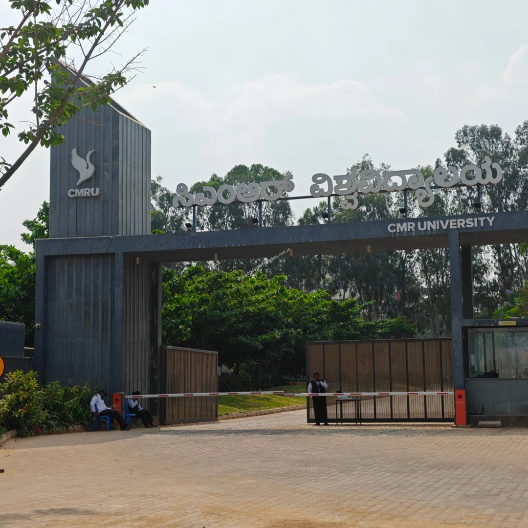 CMRU Front Facade The large grey entryway structure of CMRU showing its prominent bird logo and university name in multiple languages.
