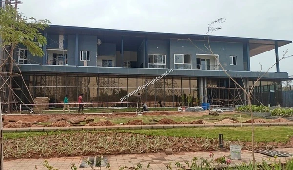 Clubhouse Site Work Exterior view of the Purva Northern Lights clubhouse showing glass facade and landscaping progress