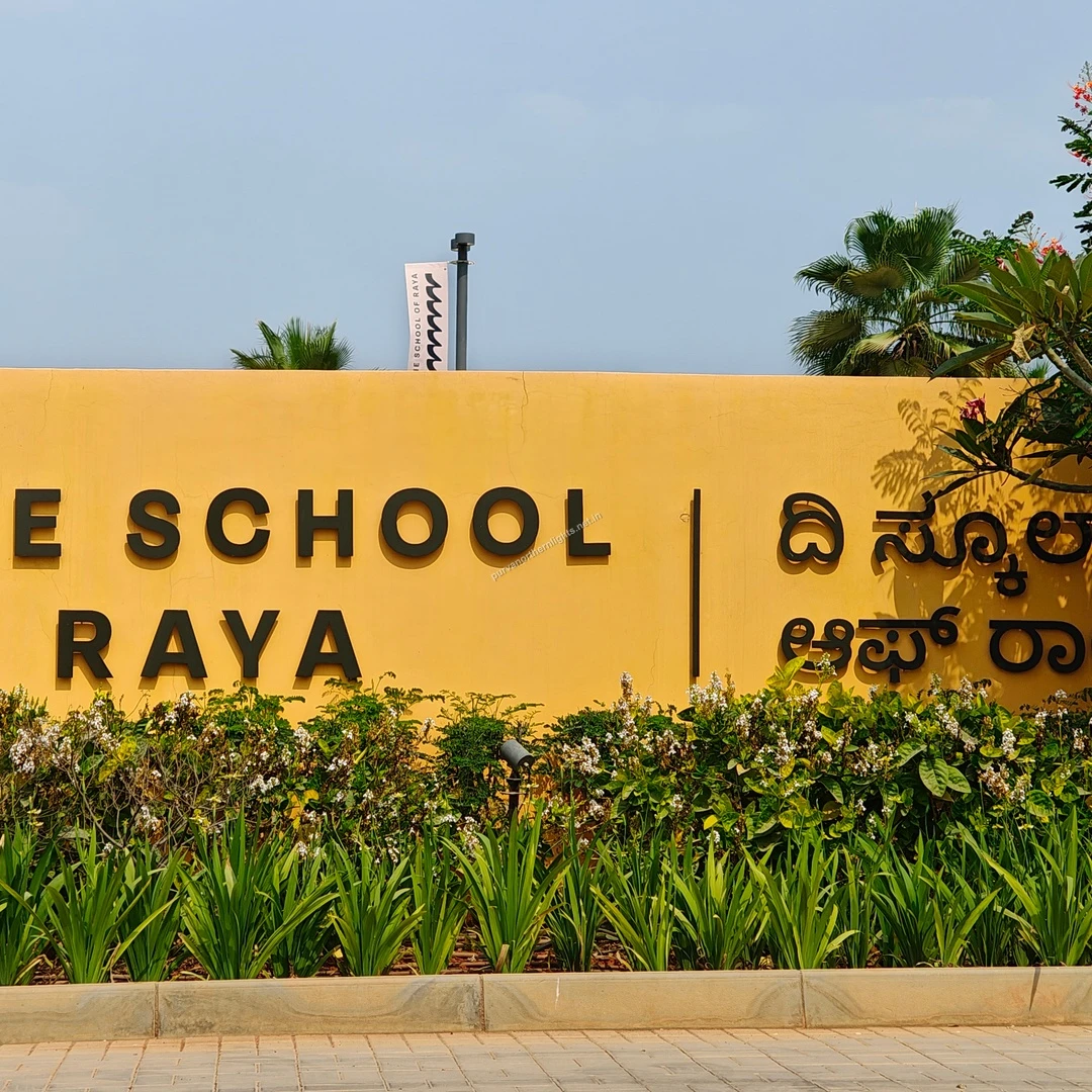 Raya Bilingual Display A wide shot showing both the English and regional language signage for The School of Raya amidst landscaped greenery.