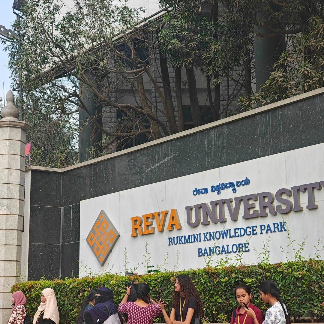 REVA University Sign The prominent marble signage of REVA University at Rukmini Knowledge Park in Bangalore with students gathered out front.