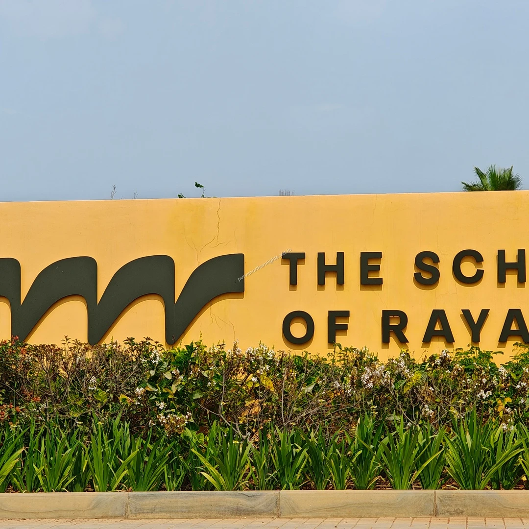 Raya Text Close Up A closer perspective of the modern typography used for The School of Raya signage set against a vibrant yellow background.