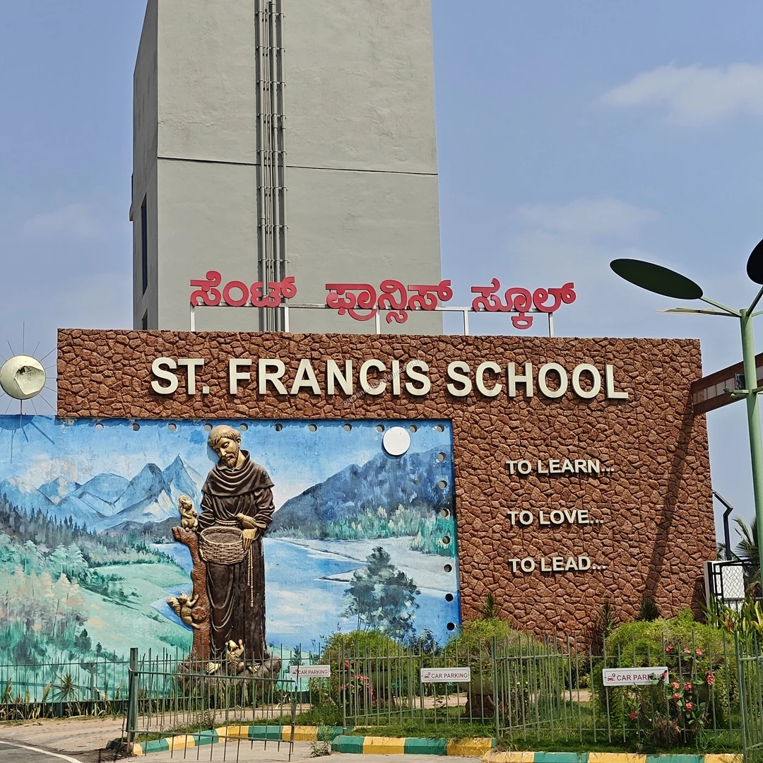 St Francis School Sign The prominent stone signage and beautiful artistic mural at the entrance of St. Francis School, an educational institution nearby.